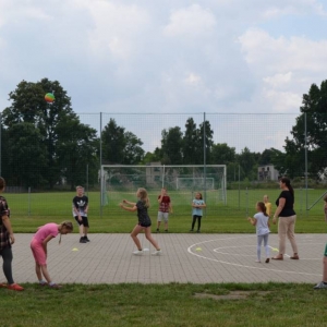 Zdjęcie przedstawia uczestników wypoczynku w czasie zabawy na boisku sportowym w Nakle Śląskim