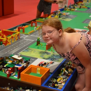 Zdjęcie przedstawia uczestników półkolonii IV turnusu w trakcie wycieczki na wystawę klocków LEGO podczas zwiedzania i wspólnej zabawy. 