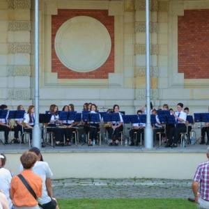 Zdjęcie przedstawia wakacyjny koncert Młodzieżowej Orkiestry Dętej ALLEGRETTO