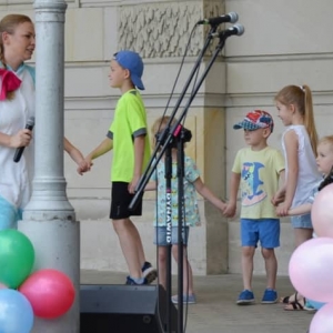 Zdjęcie przedstawia uczestników Dnia Dziecka występujących na scenie amfiteatru w świerklanieckim parku