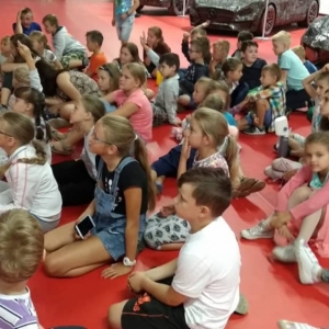 Zdjęcie przedstawia uczestników półkolonii podczas wizyty w Galerii Figur Stalowych