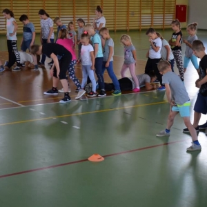 Zdjęcie przedstawia uczestników półkolonii podczas zajęć sportowych na Hali Sportowej w Nakle Śl.