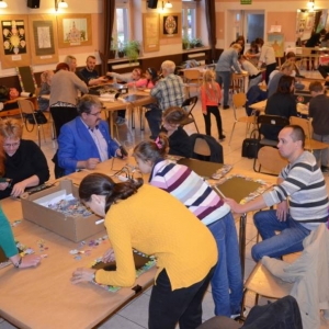 Zdjęcie przedstawia uczestników warsztatów rodzinnych podczas wykonywania swoich prac - tablic magnetycznych